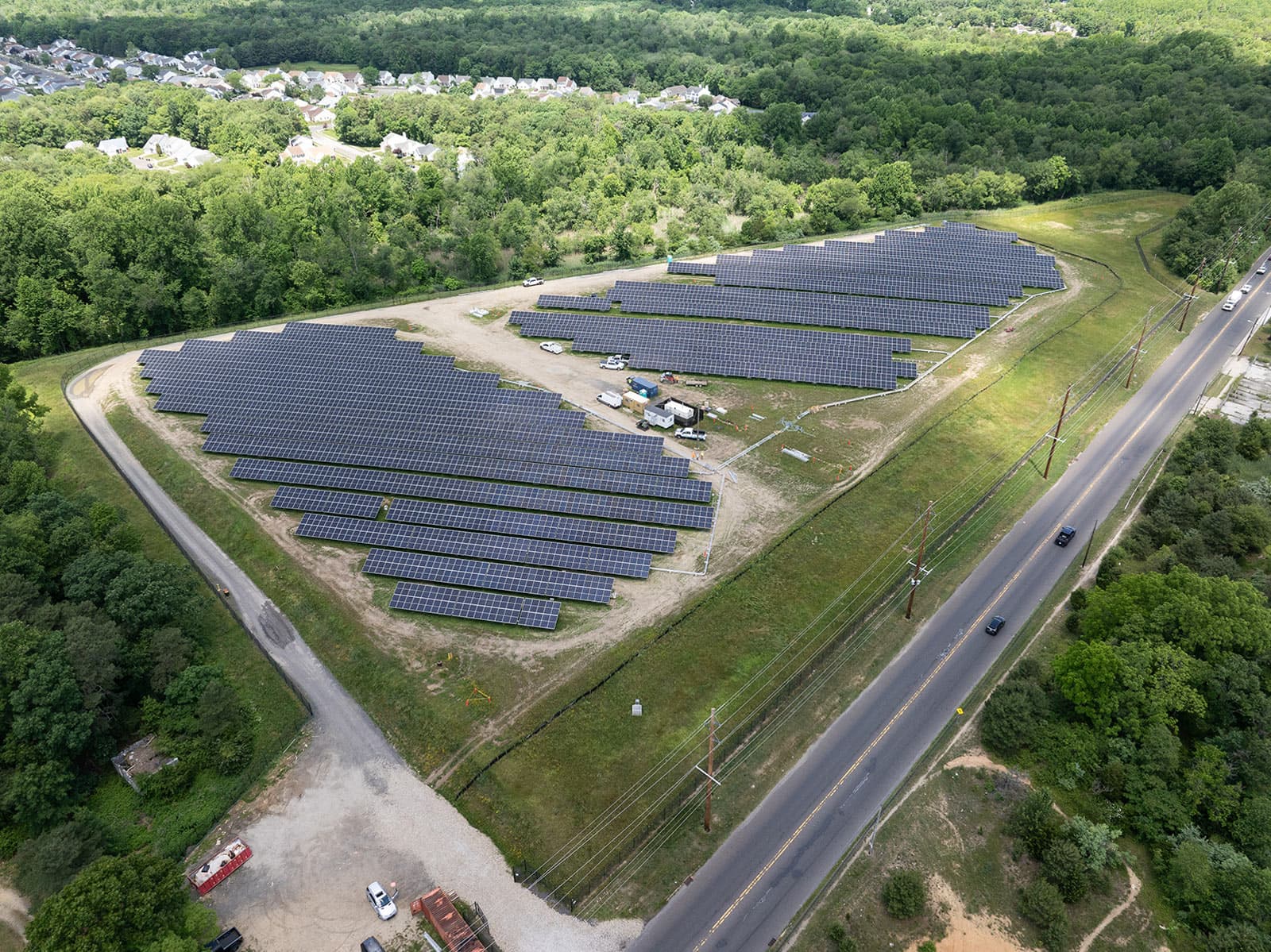An aerial view of a solar farm in a field.